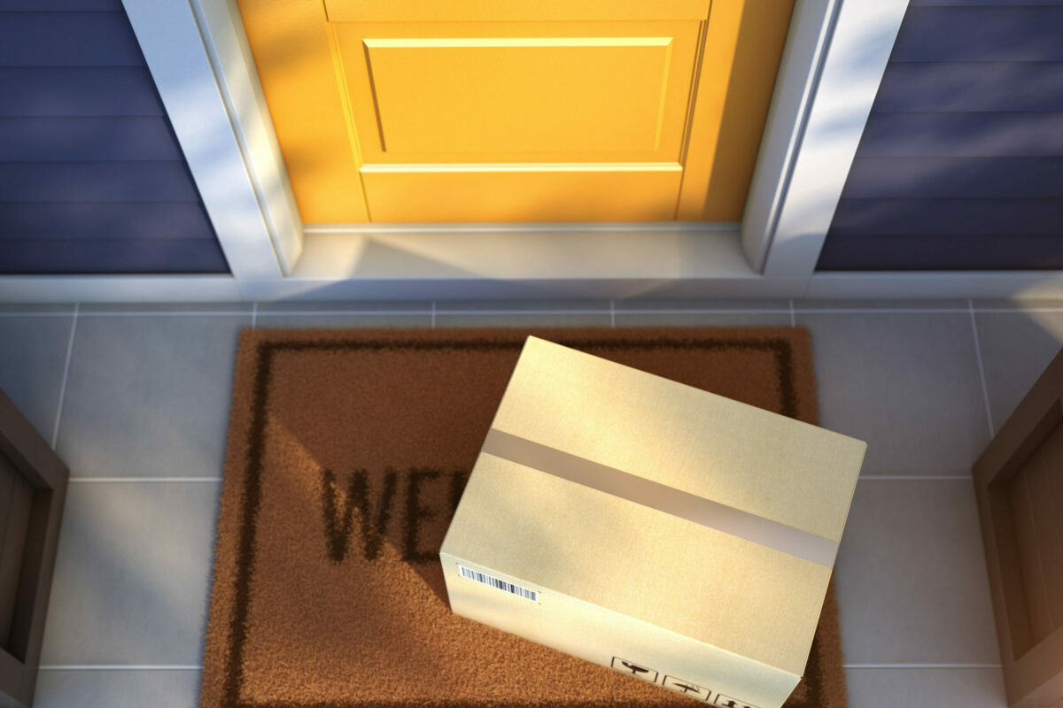 Online purchase delivery service concept Cardboard parcel box delivered outside the door Parcel on the door mat near entrance door 3d rendering