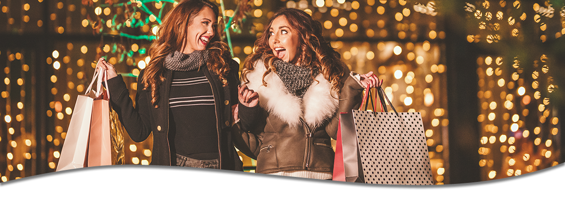 Women out shopping with twinkling lights in background