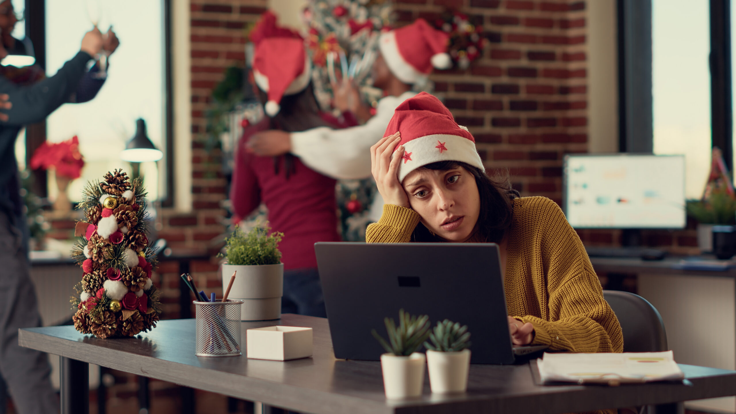 Festive people disturbing stressed woman during christmas time