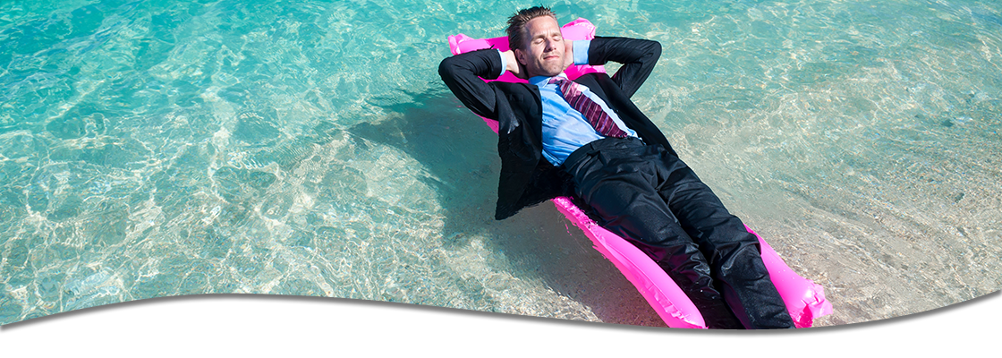 Businessman in suit floating on pool raft