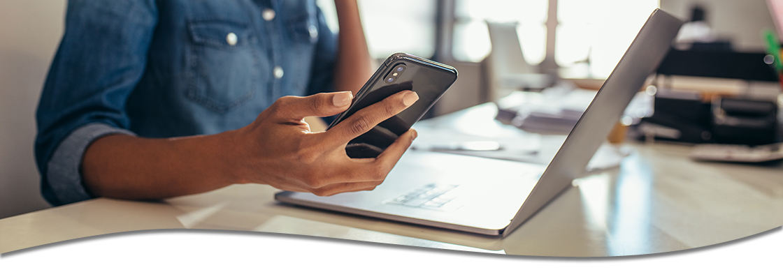 woman on laptop and phone